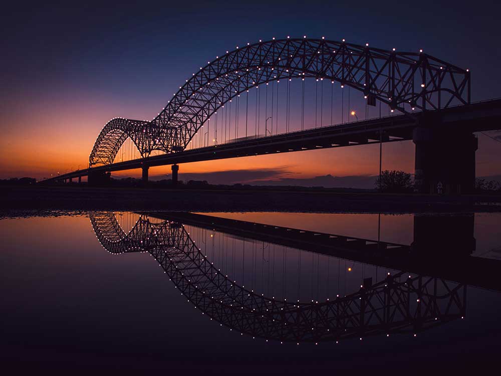 Memphis Bridge Photo by <a href="https://unsplash.com/@tkr92?utm_content=creditCopyText&utm_medium=referral&utm_source=unsplash">Terrance Raper</a> on <a href="https://unsplash.com/photos/bridge-over-body-of-water-during-night-time-sirl4pukPBw?utm_content=creditCopyText&utm_medium=referral&utm_source=unsplash">Unsplash</a>